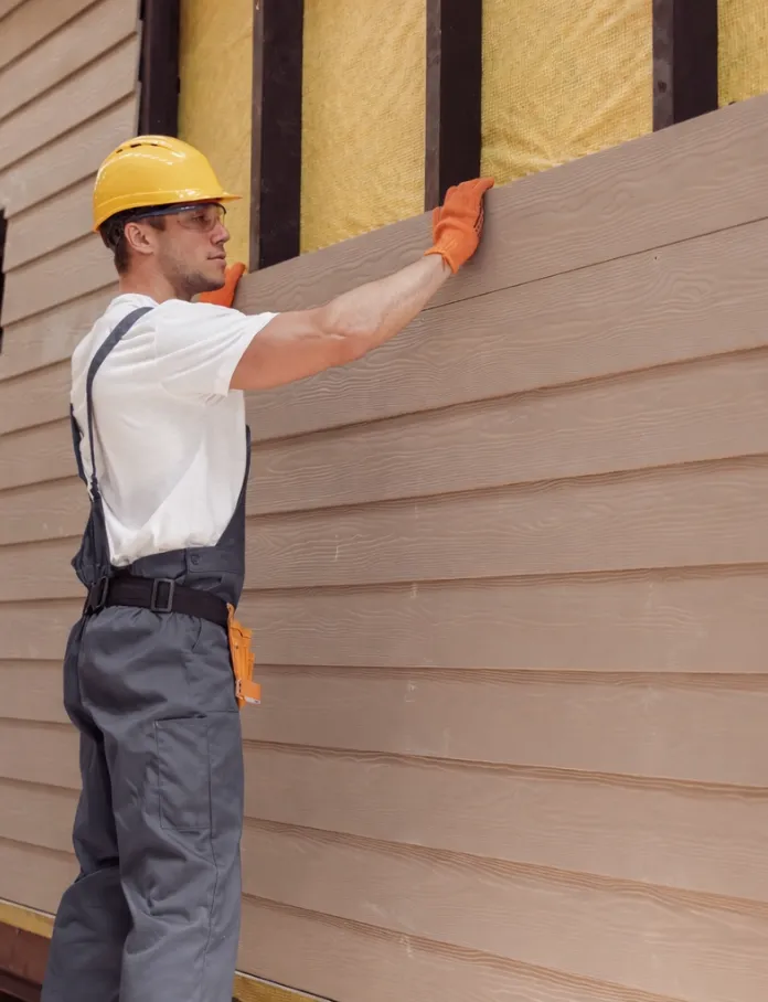 Experienced ADU builder checking framing alignment and wall level during custom accessory dwelling unit construction