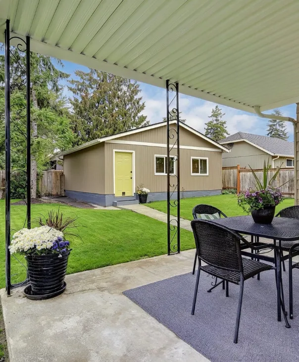 Backyard guest house in Los Angeles featuring a detached ADU with private yard, green lawn, and outdoor patio area